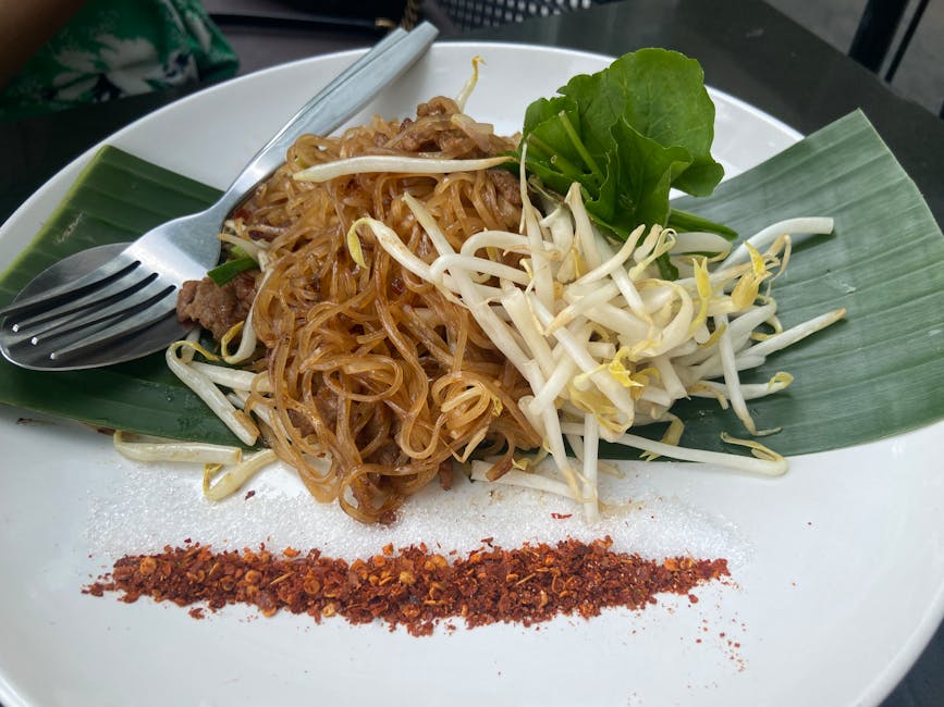 Close-up of traditional Pad Thai noodles garnished with sprouts and chili in Bangkok, Thailand.
